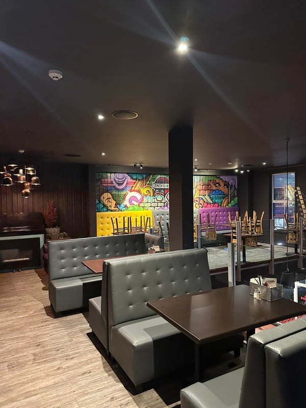 Booth dining with street-art mural